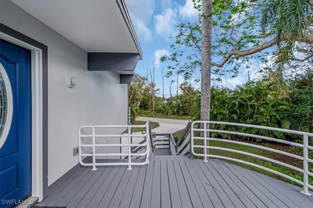 10925 Russell Road Bokeelia, FL 33922 - Photo 6 of 50 a view of deck with seating and trees
