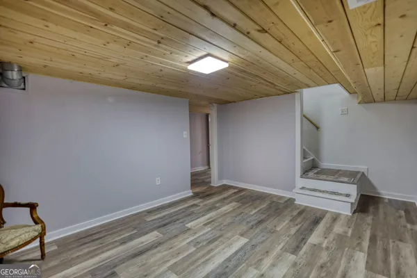 a view of a room with wooden floor