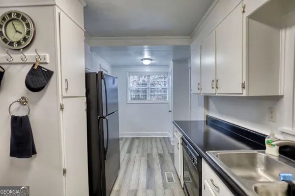 a kitchen with stainless steel appliances granite countertop a refrigerator and a sink