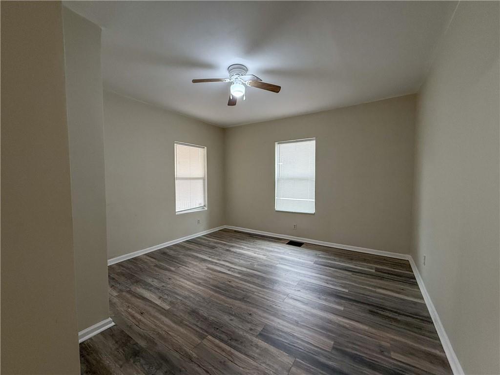 1097 Fortress Avenue Southwest Atlanta, GA 30315 - Photo 13 of 39 wooden floor in an empty room with a window