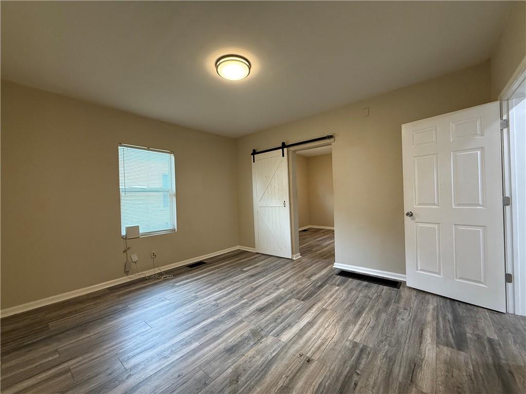 1097 Fortress Avenue Southwest Atlanta, GA 30315 - Photo 24 of 39 an empty room with wooden floor and windows