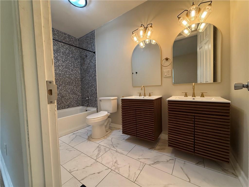 1097 Fortress Avenue Southwest Atlanta, GA 30315 - Photo 29 of 39 a bathroom with a sink a toilet and a large mirror