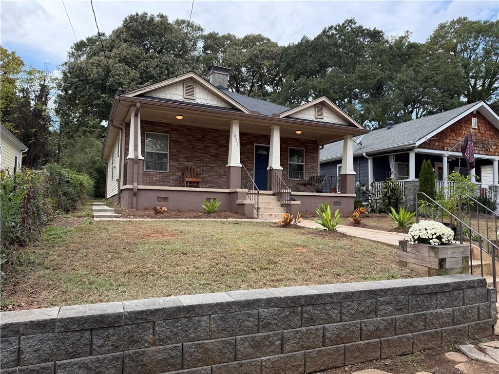 1097 Fortress Avenue Southwest Atlanta, GA 30315 - Photo 3 of 39 a front view of a house with garden