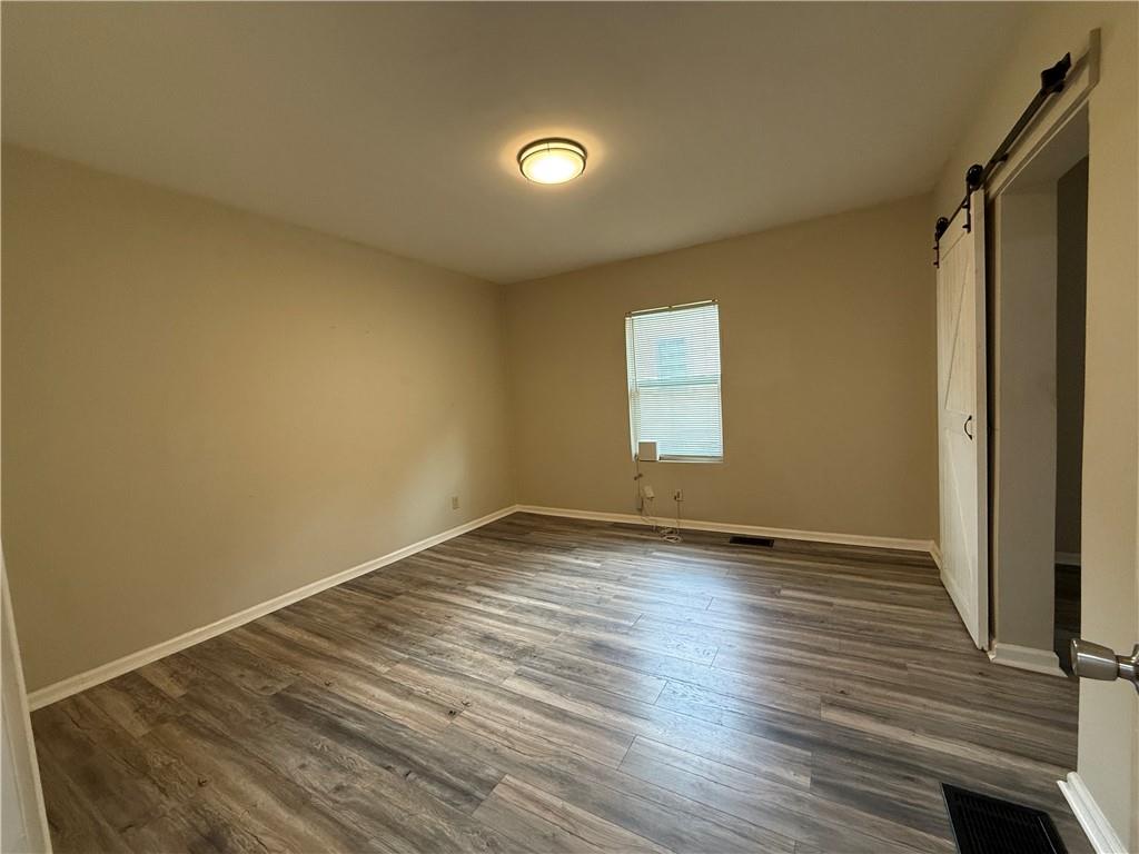 1097 Fortress Avenue Southwest Atlanta, GA 30315 - Photo 31 of 39 a view of an empty room with wooden floor and a window