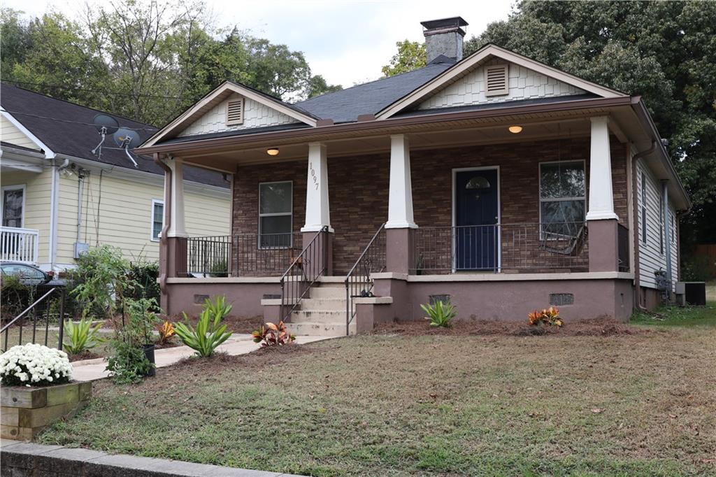 1097 Fortress Avenue Southwest Atlanta, GA 30315 - Photo 4 of 39 a front view of a house with garden