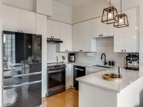 a kitchen with a sink a stove and cabinets