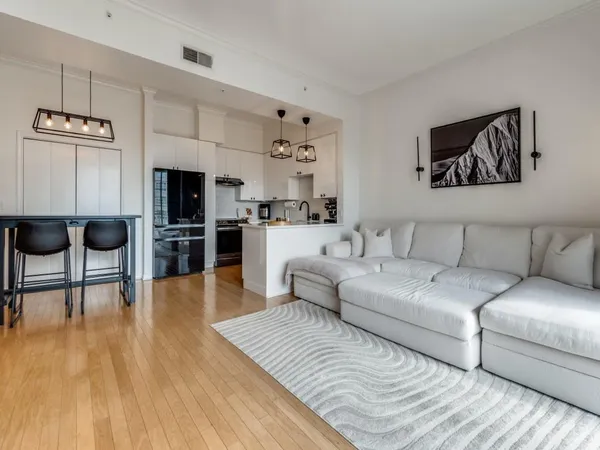 a living room with furniture and a kitchen view