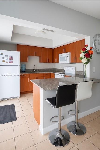 2275 Southwest 15th Street Miami, FL 33145 - Photo 4 of 10 a kitchen with stainless steel appliances granite countertop a sink counter space and cabinets