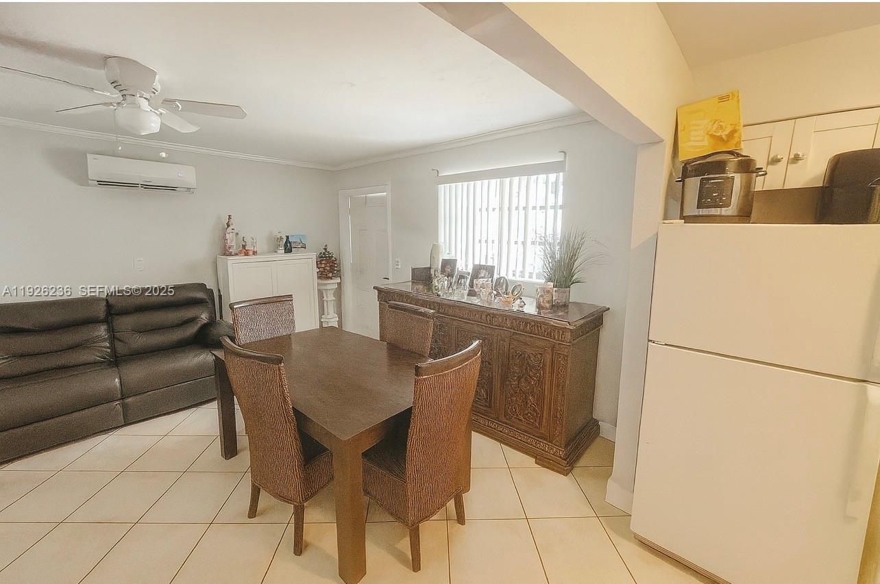 2275 Southwest 15th Street Miami, FL 33145 - Photo 5 of 10 a dining room with furniture and a refrigerator
