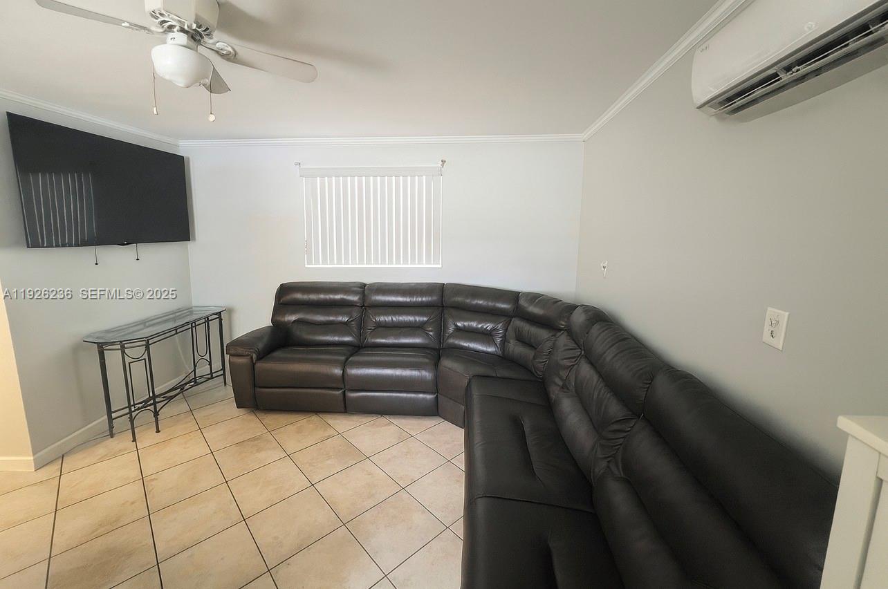 2275 Southwest 15th Street Miami, FL 33145 - Photo 6 of 10 a bedroom with a bed and a television