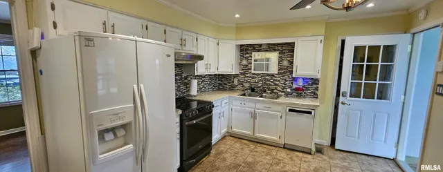 a kitchen with stainless steel appliances a refrigerator and cabinets