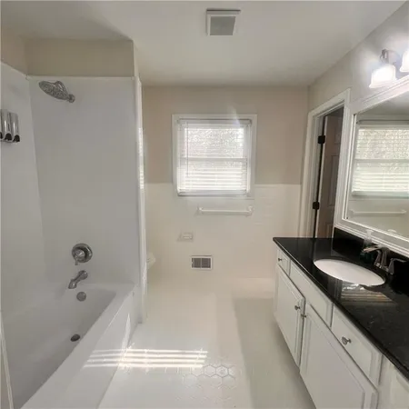 a bathroom with a toilet a sink and shower