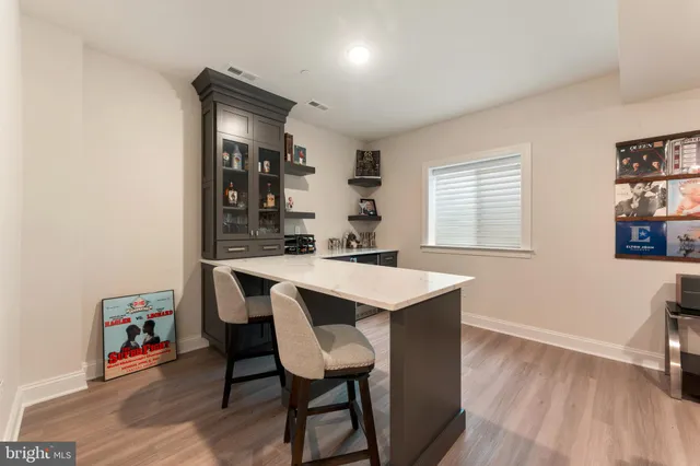 a kitchen with a sink cabinets and wooden floor