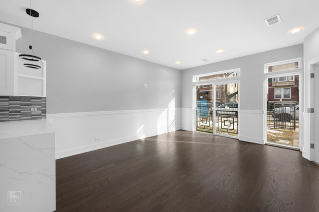 6444 South Evans Avenue, Unit 3 Chicago, IL 60637 - Photo 3 of 6 a view of an empty room with wooden floor and a window