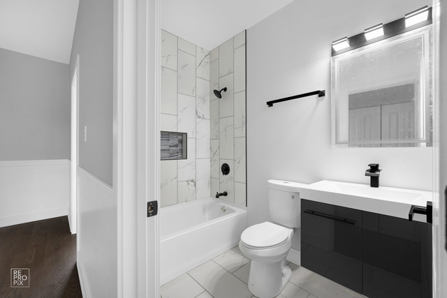 6444 South Evans Avenue, Unit 3 Chicago, IL 60637 - Photo 4 of 6 a bathroom with a sink toilet vanity and shower