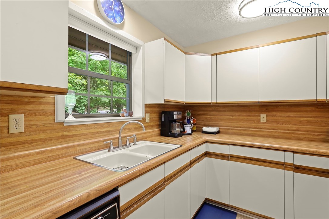 311 Pine Ridge Road Beech Mountain, NC 28604 - Photo 14 of 37 a kitchen with a sink and a window