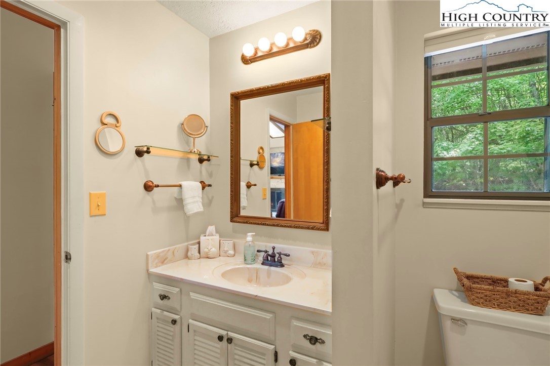311 Pine Ridge Road Beech Mountain, NC 28604 - Photo 20 of 37 a bathroom with a sink and a mirror