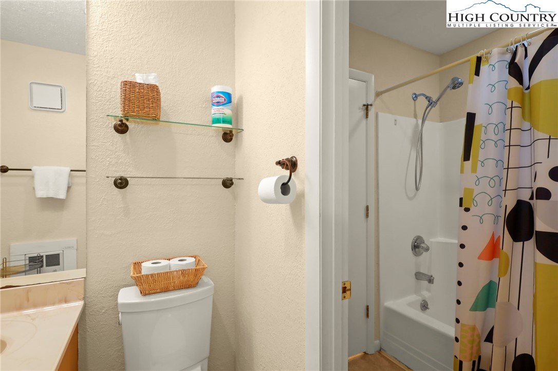 311 Pine Ridge Road Beech Mountain, NC 28604 - Photo 24 of 37 a bathroom with a shower curtain and a toilet