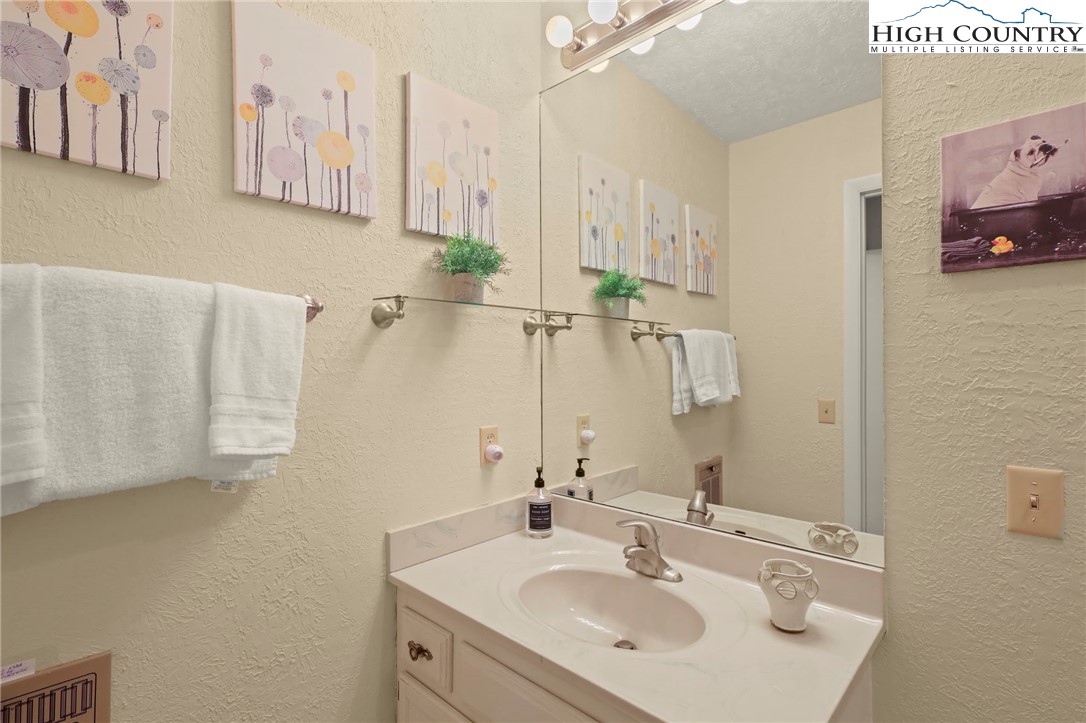 311 Pine Ridge Road Beech Mountain, NC 28604 - Photo 25 of 37 a bathroom with a sink and a mirror