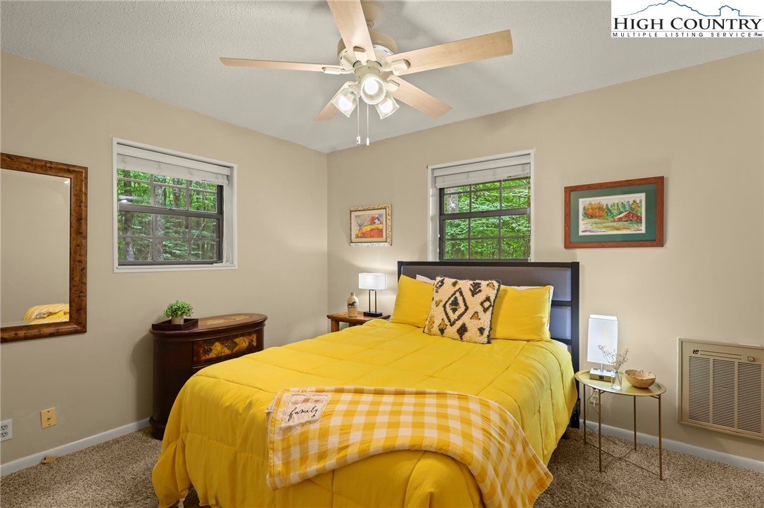 311 Pine Ridge Road Beech Mountain, NC 28604 - Photo 26 of 37 a bedroom with a bed and wooden floor