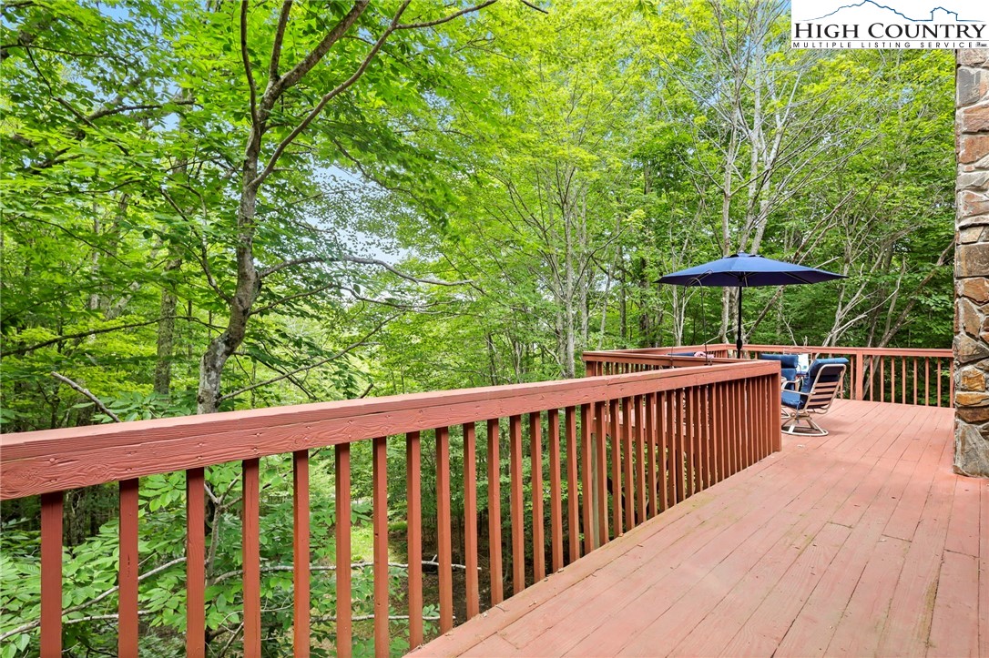 311 Pine Ridge Road Beech Mountain, NC 28604 - Photo 36 of 37 a view of a wooden deck with a yard