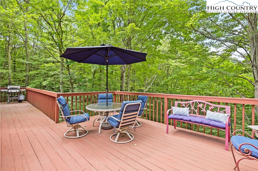 311 Pine Ridge Road Beech Mountain, NC 28604 - Photo 7 of 37 an outdoor sitting area with furniture and wooden deck