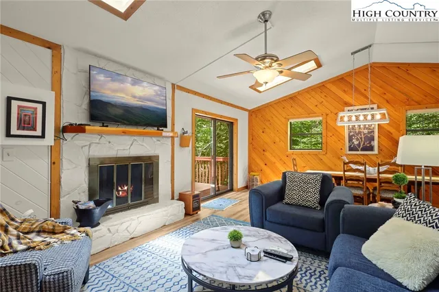 a living room with furniture a couch and a lamp next to a window