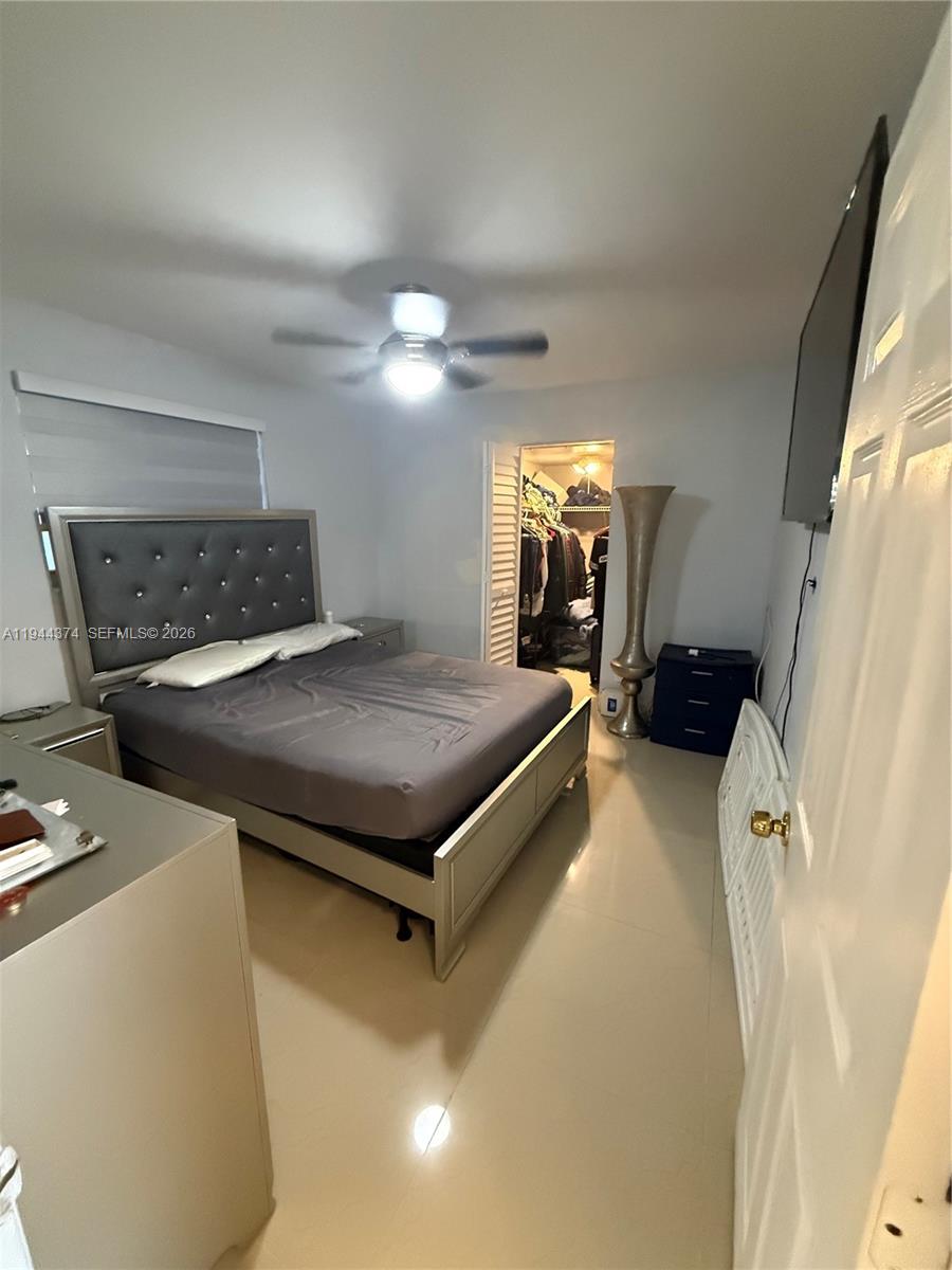 775 East 31st Street Hialeah, FL 33013 - Photo 7 of 11 a bedroom with a bed and a flat tv screen on the dresser