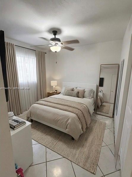 775 East 31st Street Hialeah, FL 33013 - Photo 10 of 11 a bedroom with a large bed and a chandelier