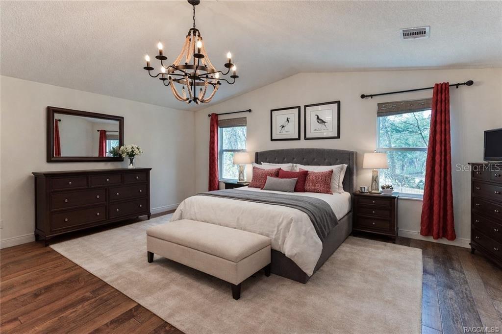 110 North Rooks Avenue Inverness, FL 34453 - Photo 17 of 34 a bedroom with a bed and a dresser