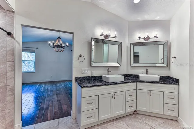 a spacious bathroom with double sink and a mirror