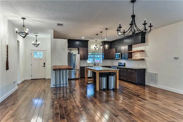 a view of kitchen with sink and wooden floor
