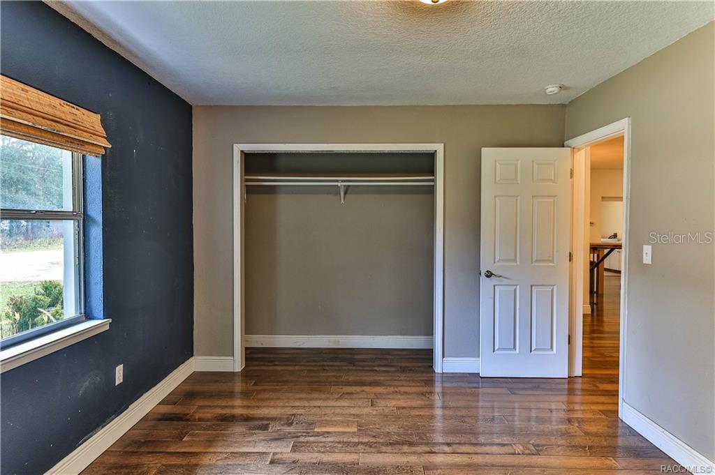 110 North Rooks Avenue Inverness, FL 34453 - Photo 27 of 34 a view of an empty room with wooden floor and a window