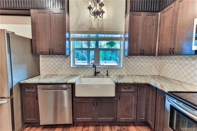 a kitchen with a sink a refrigerator and window