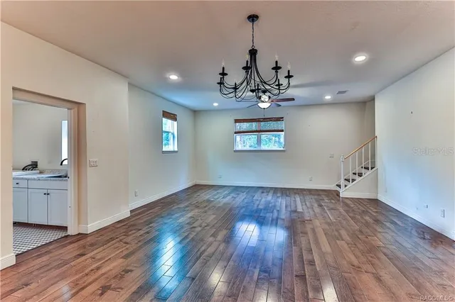 a view of a kitchen with wooden floor and a sink
