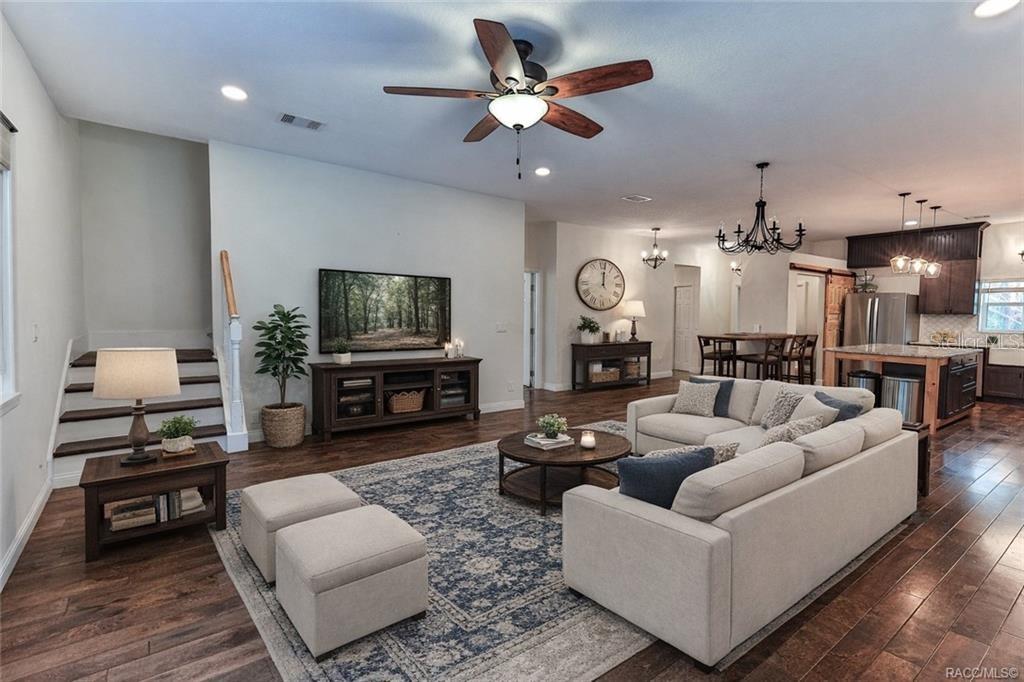 110 North Rooks Avenue Inverness, FL 34453 - Photo 10 of 34 a living room with furniture and a flat screen tv with kitchen view