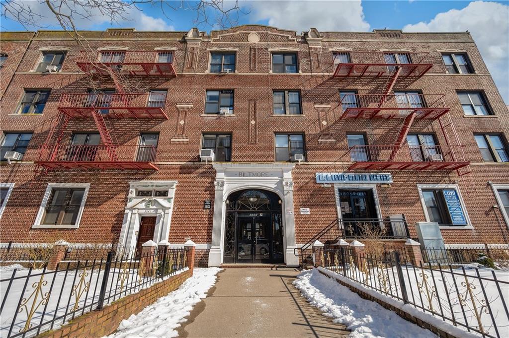 a front view of a brick building with many windows