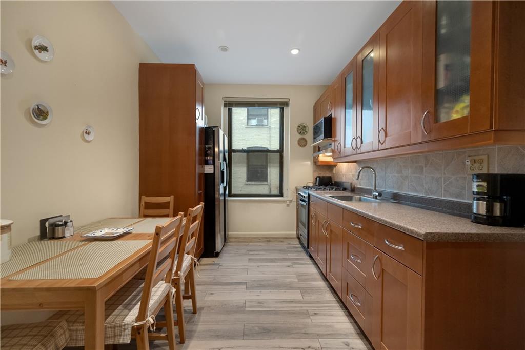 3045 Ocean Parkway, Unit 2D Brooklyn, NY 11235 - Photo 9 of 10 a kitchen with granite countertop a sink a counter top space and stainless steel appliances