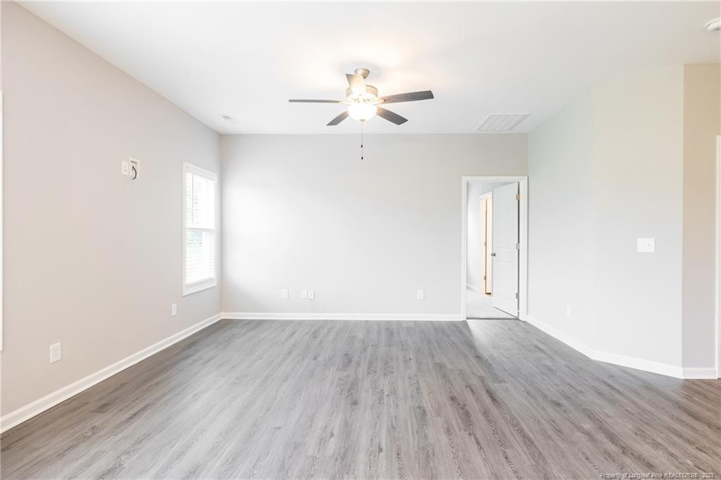 260 Carolina Church Road St. Pauls, NC 28384 - Photo 19 of 32 wooden floor in an empty room with a window