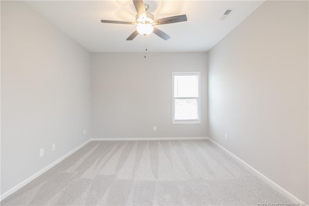 260 Carolina Church Road St. Pauls, NC 28384 - Photo 27 of 32 an empty room with a window and a fan