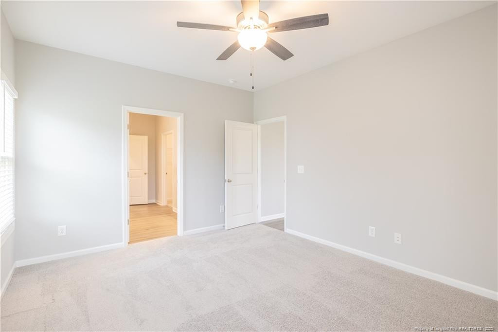 260 Carolina Church Road St. Pauls, NC 28384 - Photo 28 of 32 an empty room with closet and a chandelier fan