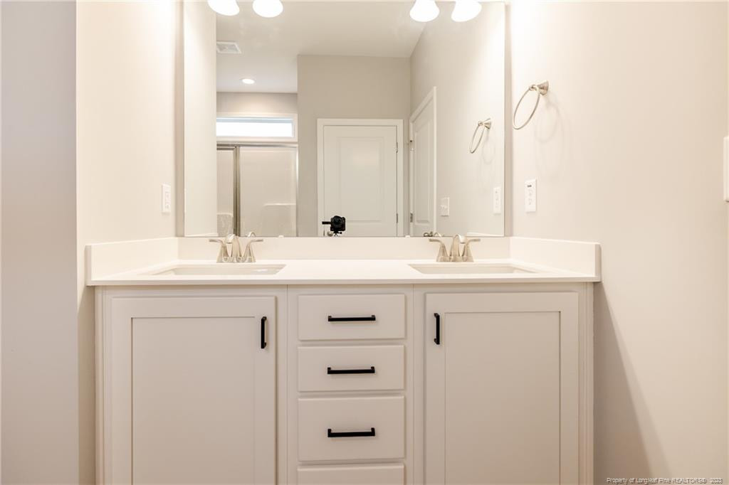 260 Carolina Church Road St. Pauls, NC 28384 - Photo 29 of 32 a bathroom with a sink vanity and a mirror