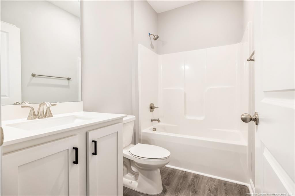 260 Carolina Church Road St. Pauls, NC 28384 - Photo 10 of 32 a bathroom with a sink a toilet and a mirror