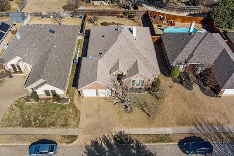 an aerial view of a house with a yard