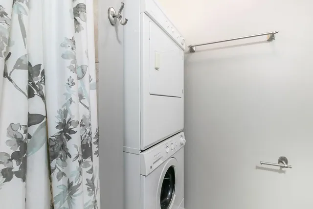 a view of a bathroom with a shower and a shower curtain