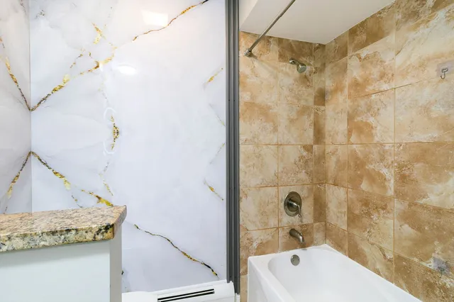 a bathroom with a tub and shower