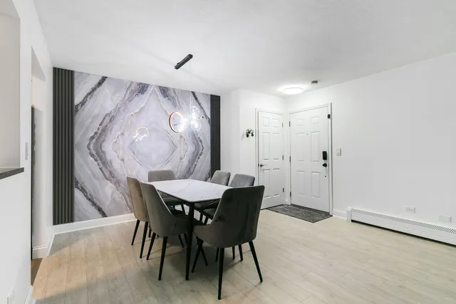 a view of a dining room with furniture and chandelier