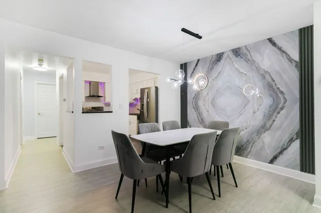 a view of a dining room with furniture and wooden floor