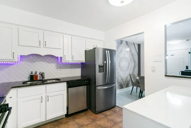 a kitchen with a sink stainless steel appliances and cabinets