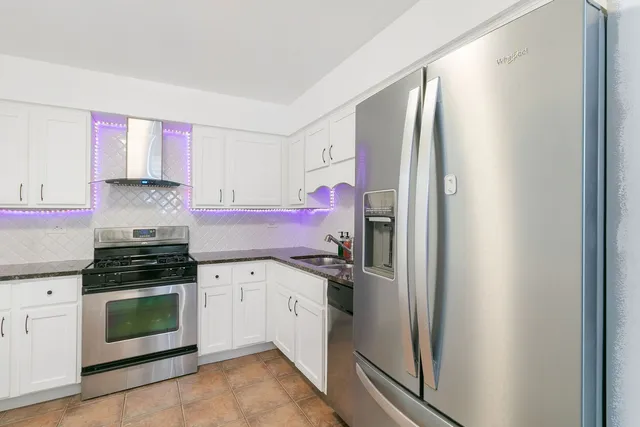 a kitchen with a refrigerator stove and sink